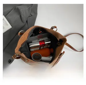 Detailed internal capacity of brown leather tote showing storage of daily essentials