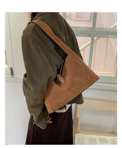 Detail view of the adjustable metal buckle on a brown suede vintage hobo bag strap