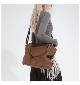 Detailed side view of a large brown leopard print tote bag on model for size and style