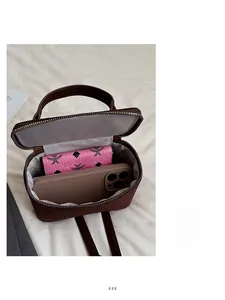 Interior view of brown faux suede bag showing space for long wallet and smartphone