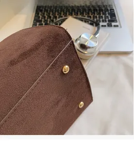 Detail of durable bag bottom featuring golden protective studs and suede texture