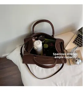 Macro shot of spacious interior in a dark brown suede tote bag with daily essentials