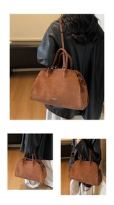 Detail of caramel suede tote bag featuring reinforced handles and adjustable strap