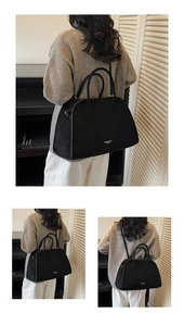 Detailed view of the large capacity black suede tote bag with logo and adjustable strap