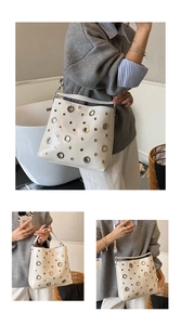Vue détaillée du sac en cuir crème avec de grands œillets métalliques et bandoulière large