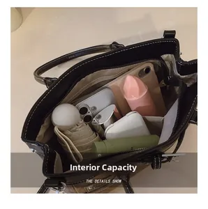Macro shot showing internal compartments of the large capacity retro tote bag with daily items