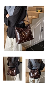 Gros plan sur le sac en cuir marron foncé brillant avec œillets métalliques argentés