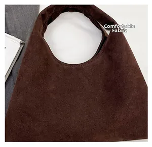 Close-up of dark brown suede tote bag showing premium matte texture and seamless handle