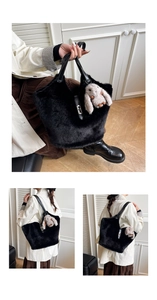 Detail of black plush tote bag with leather handle, metal clasp and rabbit charm