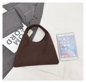 Brown suede tote bag shown with a tablet and magazine to demonstrate spacious capacity