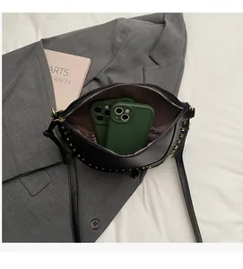Detail view of the black crescent bag showing its spacious interior and inner zipper pocket