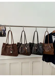 Detail view of four large vintage tote bags in leopard, black, brown, and coffee shades