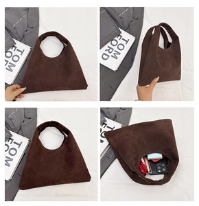 Detail view of large dark brown suede tote bag showing internal capacity and soft texture