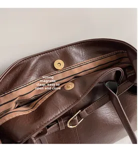 Detail of vintage tote bag showing strong magnetic closure and striped interior lining