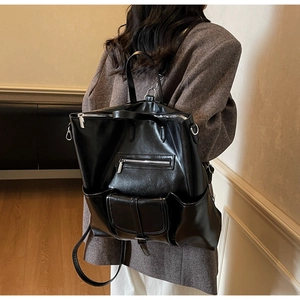 Détail d'un grand sac à dos en cuir PU noir avec plusieurs poches et sangles réglables
