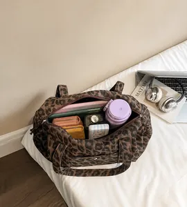 Spacious interior of leopard print tote bag filled with daily essentials for commuting