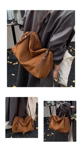 Detail of suede crossbody bag with zipper closure and fine leather strap in brown