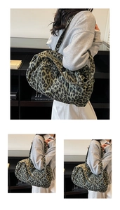 Macro view of leopard print tote bag detailing wide shoulder straps and zip closure