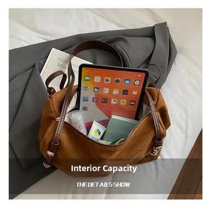 Macro shot showing the spacious interior of the brown suede handbag with an iPad