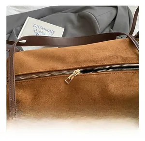 Detail of premium gold zipper and brown suede texture on a vintage Boston bag