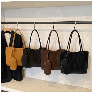 Detail view of four tote bags in ginger, brown and black with matching small coin purses