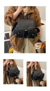 Detail showing the pleated black faux leather backpack with metallic snap side pockets