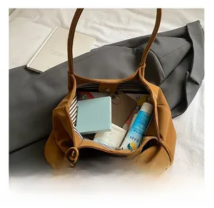 Interior view of brown tote bag with striped lining showing large storage capacity