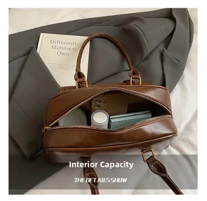 Top view of deep brown Boston bag interior showing spacious capacity for cosmetics