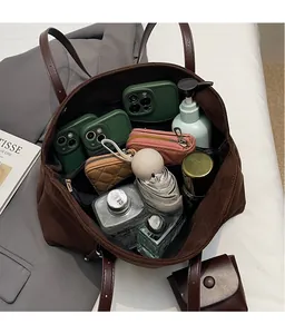 Macro view of large capacity dark brown tote bag showing internal storage for essentials