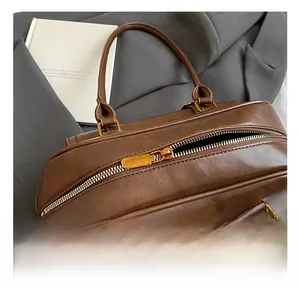 Close-up of golden hardware and premium zipper on dark brown vintage bowling bag