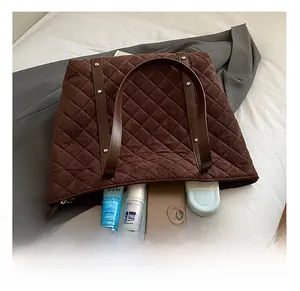 Spacious brown quilted tote bag showing interior storage for skincare and electronics
