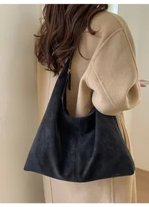 Detail of soft matte black tote bag with premium golden metal zipper closure