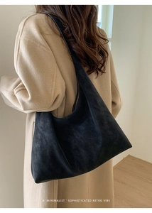 Minimalist black suede hobo bag shown from the side on model for actual wearing effect