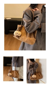 Brown suede tote bag detail featuring soft texture and a cute plush bear charm accessory