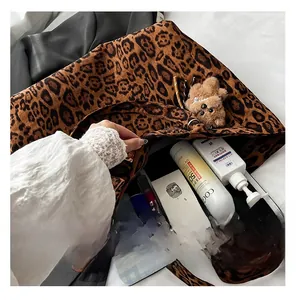 Interior view of leopard print tote bag showing large capacity for gadgets and cosmetics