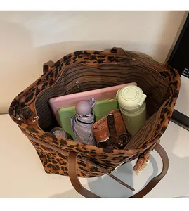 Interior view of large leopard print tote bag with items showing spacious storage