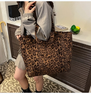 Detailed view of the leopard print tote bag styled as a chic crossbody shoulder bag