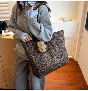 Detail shot of large leopard print tote bag with cute bear charm for daily commute