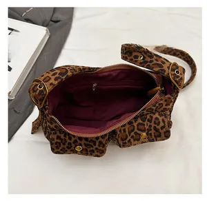 Detailed top view of leopard print shoulder bag showing red lining and internal pocket