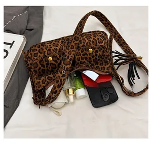 Detailed view of leopard print baguette bag showing interior storage capacity and pockets