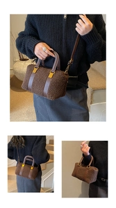 Detail of brown plush teddy Boston bag with leather straps and gold-tone metal hardware
