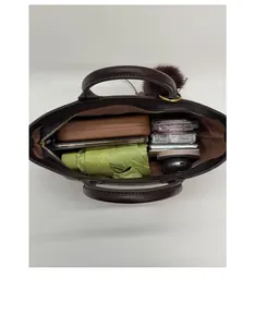 Top view of large capacity leopard tote interior with folding umbrella and cosmetics
