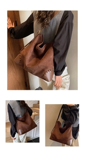 Detail of contrast stitching and suede texture on this large brown shoulder tote bag