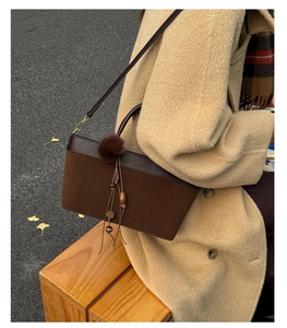 Detail of vintage suede leopard tote with brown leather trim and tassel bag charm