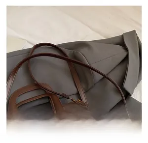 Detail of adjustable brown leather shoulder strap on a plush autumn fleece handbag
