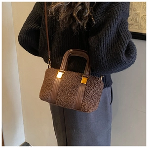 Detailed view of the dark brown teddy fur texture and premium leather strap on the Boston bag