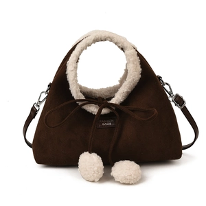 Retro coffee suede bucket bag with plush white fur handles and drawstring pom-poms