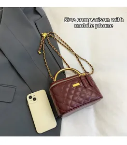 Detail of burgundy quilted mini bag with gold chain strap and phone size comparison