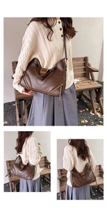 Detailed view of dark brown vintage shoulder bag with metal buckle and gold hardware