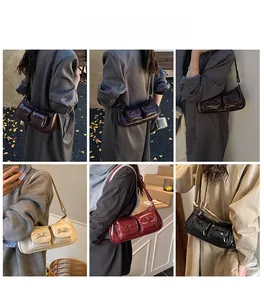 Detail of vintage glossy leather shoulder bag with bow accents and dual front pockets
